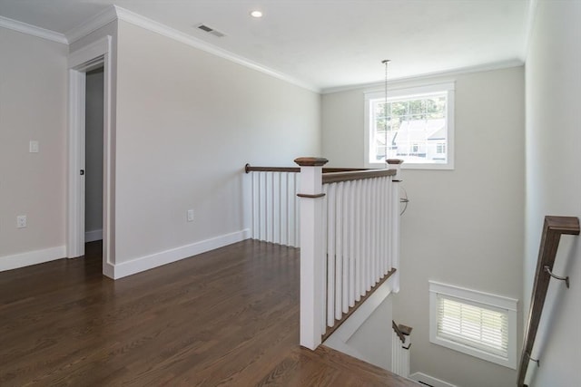 hallway with an upstairs landing, dark wood finished floors, baseboards, recessed lighting, and crown molding