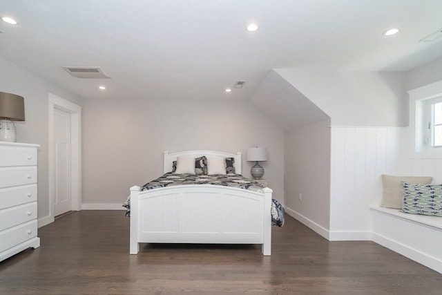 bedroom featuring wood finished floors, recessed lighting, a wainscoted wall, and baseboards