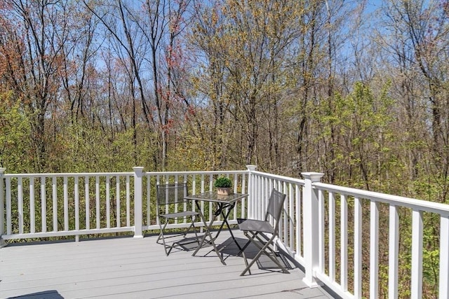 wooden deck with a forest view