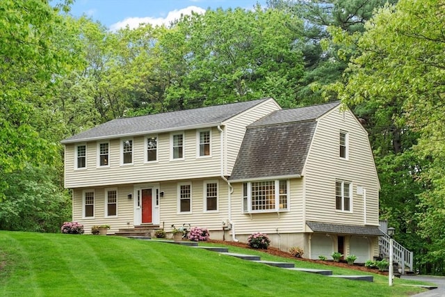 163 Candlestick Rd, North Andover, MA 01845 - view of front of house featuring a front yard, roof with shingles, a gambrel roof, and view of wooded area