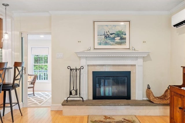 163 Candlestick Rd, North Andover, MA 01845 - detailed view of wood finished floors, a glass covered fireplace, a wall mounted air conditioner, ornamental molding, and baseboards
