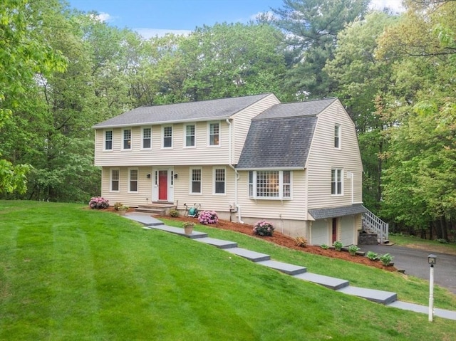 163 Candlestick Rd, North Andover, MA 01845 - view of front of home with an attached garage, roof with shingles, a front yard, a gambrel roof, and asphalt driveway