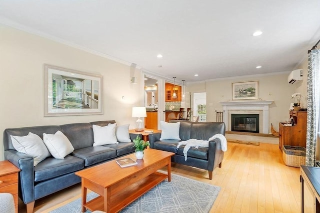 163 Candlestick Rd, North Andover, MA 01845 - living room with light wood-style flooring, ornamental molding, recessed lighting, a wall mounted air conditioner, and a glass covered fireplace