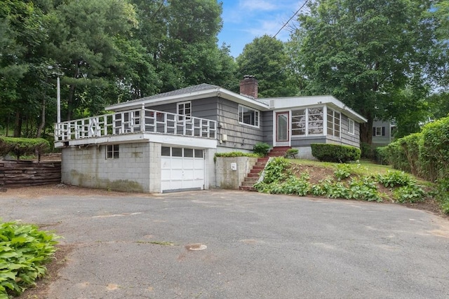 14 Forty Steps Ln, Nahant, MA 01908 - view of front of property featuring driveway, stairs, a sunroom, a chimney, and a garage