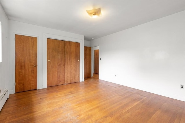 14 Forty Steps Ln, Nahant, MA 01908 - unfurnished bedroom with light wood-type flooring, two closets, and a baseboard radiator