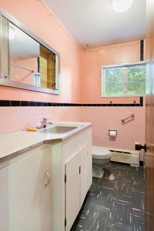 14 Forty Steps Ln, Nahant, MA 01908 - bathroom with a baseboard heating unit, vanity, and tile walls