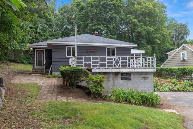 14 Forty Steps Ln, Nahant, MA 01908 - back of property with roof with shingles, a lawn, entry steps, and a chimney