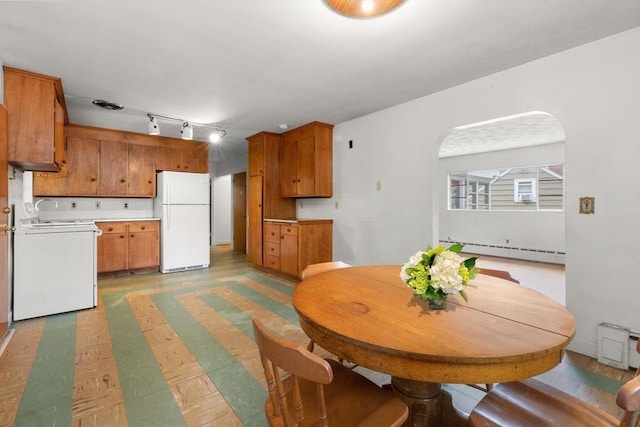 14 Forty Steps Ln, Nahant, MA 01908 - dining area featuring a baseboard radiator, track lighting, and arched walkways
