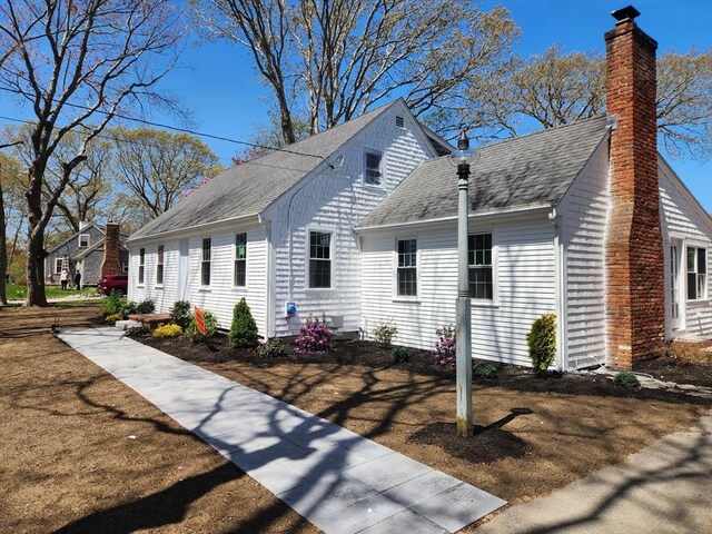 150 Boles Rd, Marshfield, MA 02050 - view of side of property featuring a shingled roof and a chimney