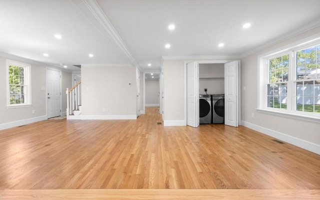 150 Boles Rd, Marshfield, MA 02050 - unfurnished living room featuring separate washer and dryer, crown molding, stairs, healthy amount of natural light, and light wood finished floors