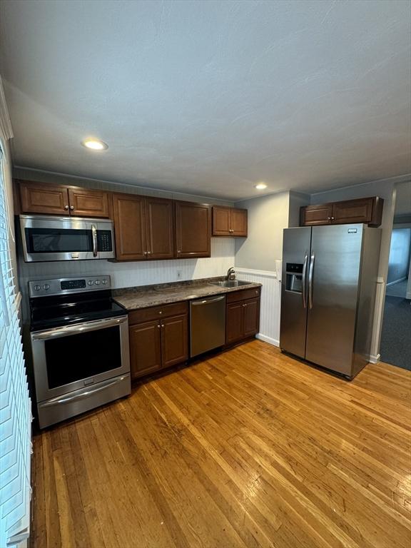 kitchen featuring sink, stainless steel appliances, and light hardwood / wood-style flooring