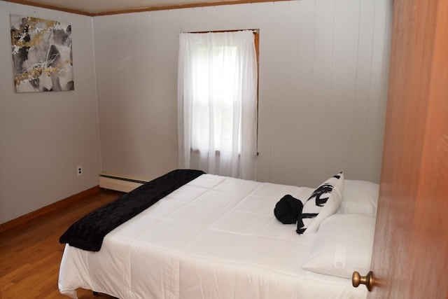 130 Windham Rd, Boston, MA 02136 - bedroom featuring baseboard heating, wood finished floors, and baseboards