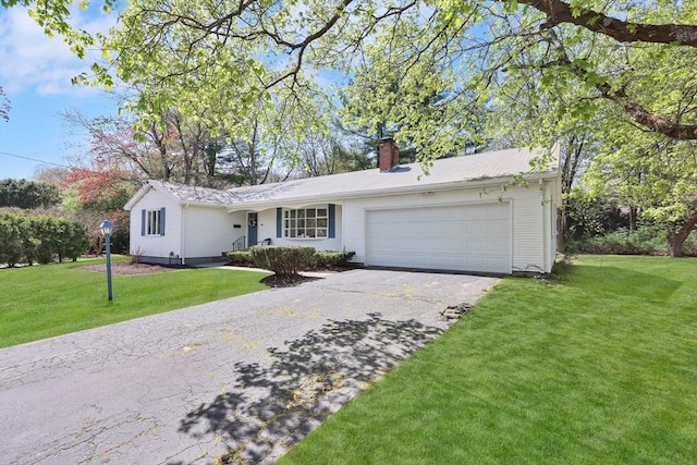 single story home with a garage, a chimney, driveway, and a front yard