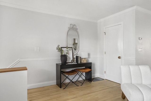 entryway featuring ornamental molding and light hardwood / wood-style flooring