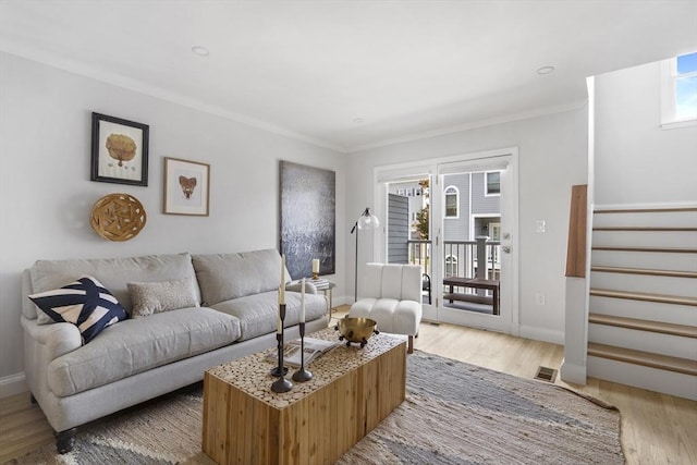 living room with hardwood / wood-style floors and ornamental molding
