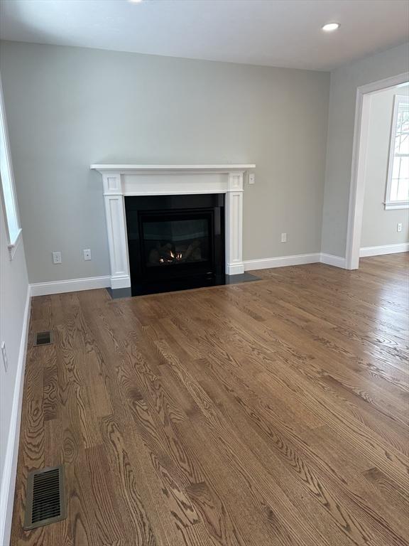 unfurnished living room with hardwood / wood-style flooring