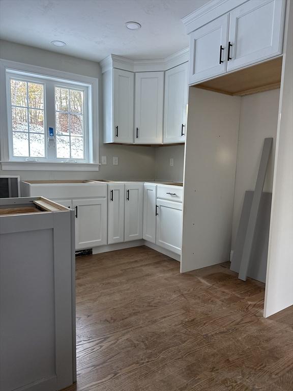 kitchen featuring white cabinetry and dark hardwood / wood-style floors