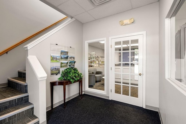 interior space with carpet flooring and a drop ceiling