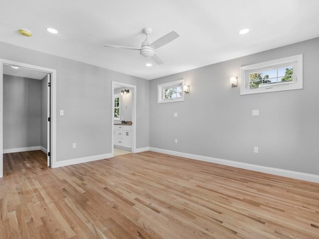 interior space with a ceiling fan, recessed lighting, baseboards, and light wood finished floors