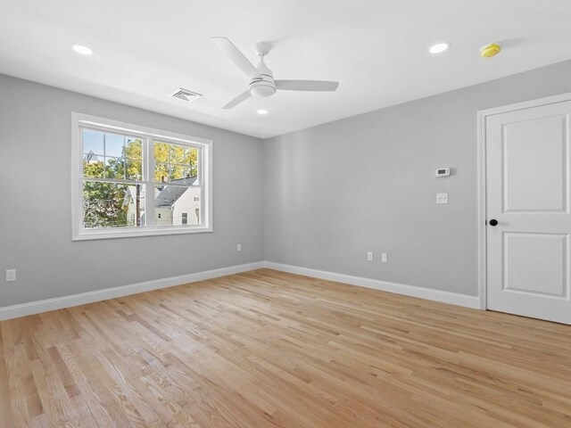 unfurnished room featuring light wood-type flooring, baseboards, and visible vents