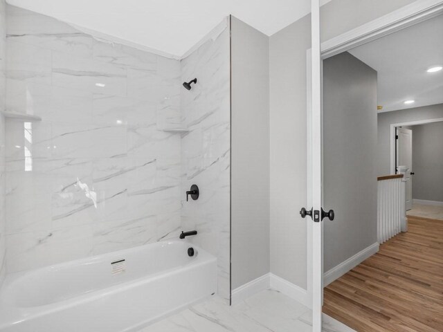 bathroom with marble finish floor, recessed lighting, bathing tub / shower combination, and baseboards