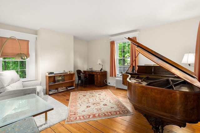 32 School St, Belmont, MA 02478 - living area with hardwood / wood-style flooring, radiator, and a desk
