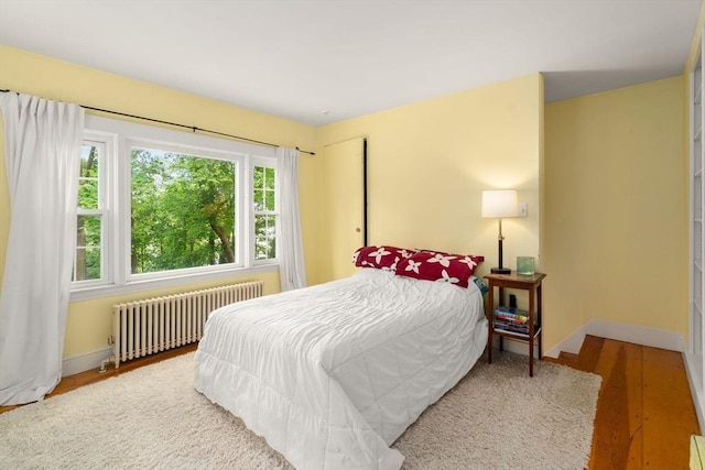 32 School St, Belmont, MA 02478 - bedroom with radiator heating unit, baseboards, and wood finished floors