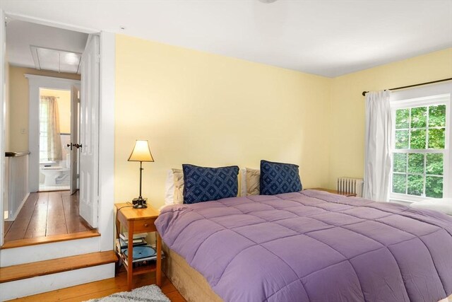32 School St, Belmont, MA 02478 - bedroom featuring radiator, wood-type flooring, and attic access