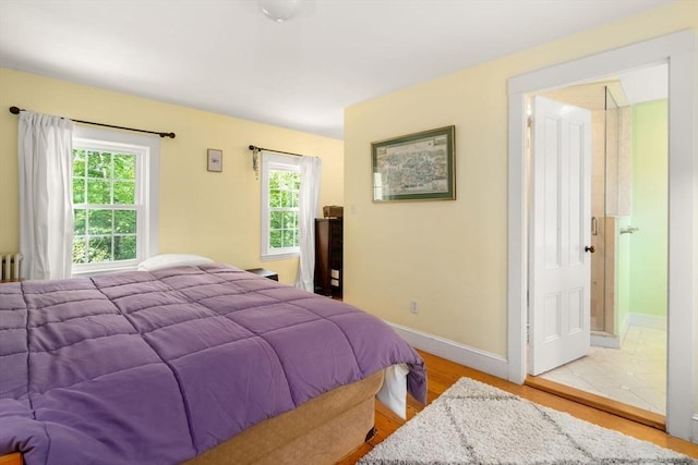 32 School St, Belmont, MA 02478 - bedroom featuring light wood-type flooring, baseboards, and radiator heating unit