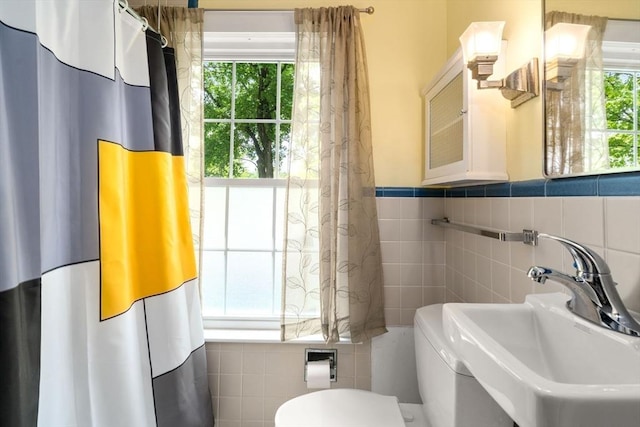 32 School St, Belmont, MA 02478 - bathroom featuring tile walls, toilet, a sink, and wainscoting