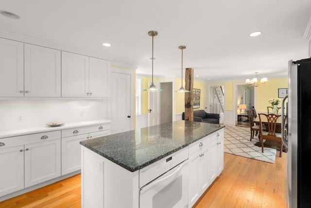 32 School St, Belmont, MA 02478 - kitchen featuring white oven, freestanding refrigerator, a chandelier, white cabinets, and recessed lighting