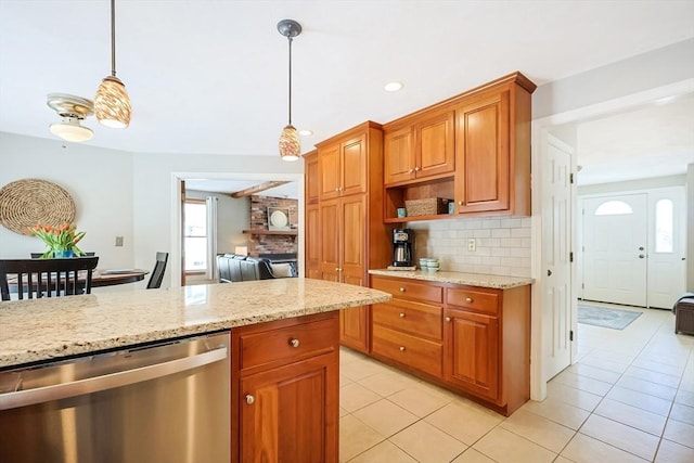 kitchen featuring decorative backsplash, dishwasher, light stone countertops, pendant lighting, and light tile patterned flooring