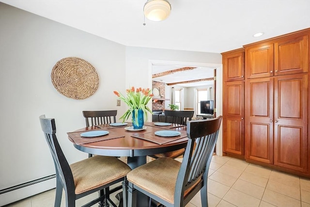 dining space featuring baseboard heating, light tile patterned flooring, and beam ceiling