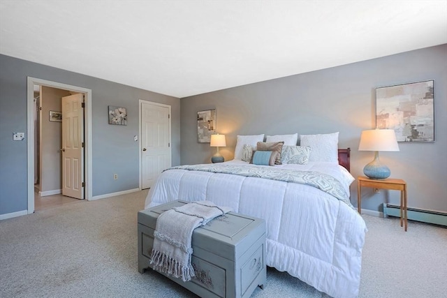 bedroom with baseboard heating, light carpet, and baseboards