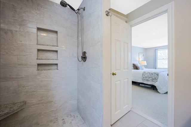 ensuite bathroom with a tile shower and connected bathroom