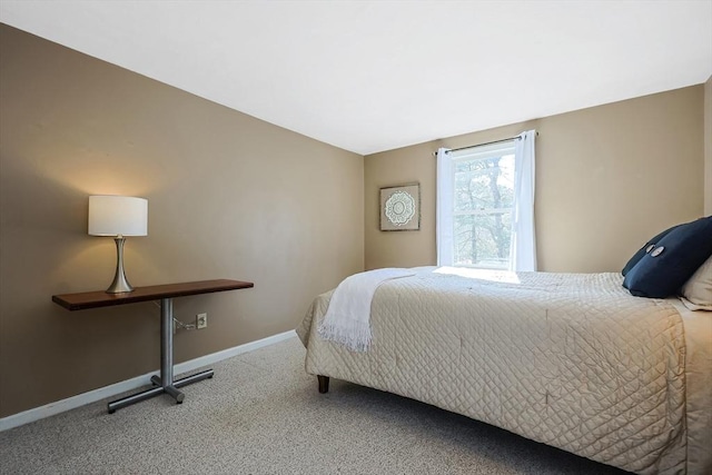 bedroom with carpet floors and baseboards