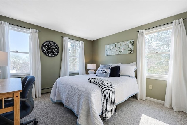 carpeted bedroom featuring a baseboard radiator and baseboards