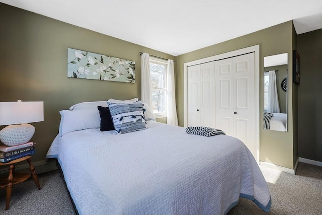 carpeted bedroom with a closet and baseboards