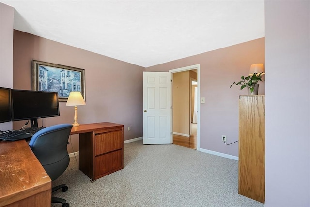 home office featuring baseboards and light colored carpet