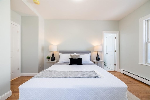 17 Norcross St Unit 3, Arlington, MA 02474 - bedroom with a baseboard radiator, light wood-type flooring, and baseboards