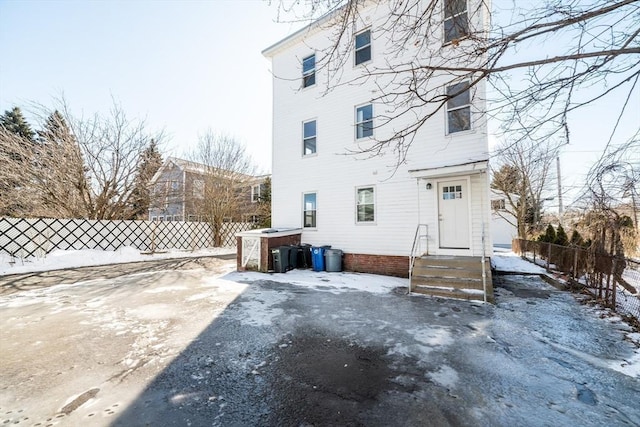 17 Norcross St Unit 3, Arlington, MA 02474 - snow covered back of property featuring entry steps