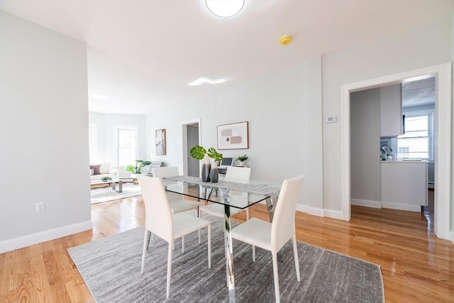 17 Norcross St Unit 3, Arlington, MA 02474 - dining room with healthy amount of natural light, wood finished floors, and baseboards
