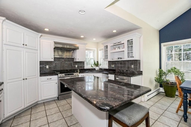 4 Olde Logging Rd, Marion, MA 02738 - kitchen featuring stainless steel electric stove, baseboard heating, light tile patterned floors, wall chimney exhaust hood, and tasteful backsplash
