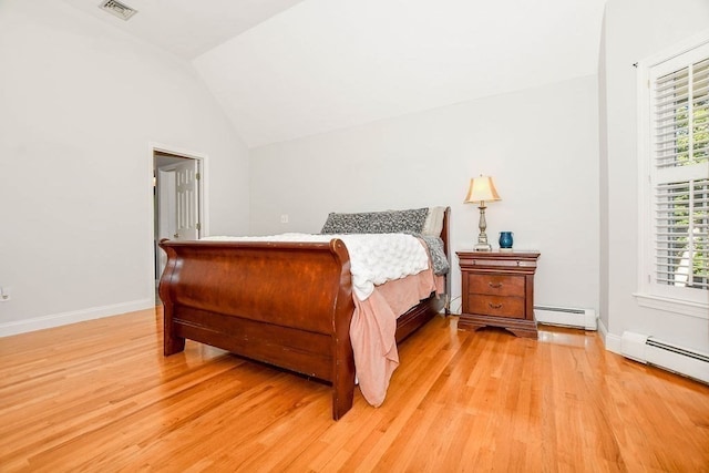 bedroom with a baseboard radiator, light hardwood / wood-style flooring, and lofted ceiling