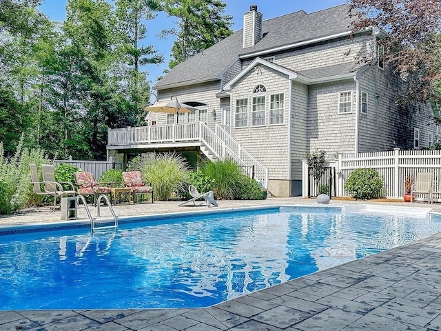 view of swimming pool with a wooden deck