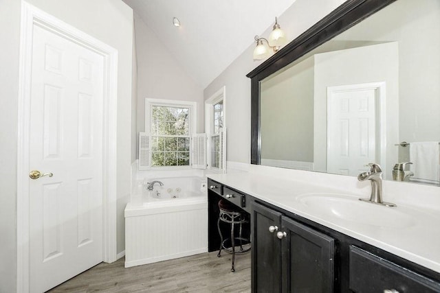 4 Olde Logging Rd, Marion, MA 02738 - full bath with wood finished floors, vaulted ceiling, vanity, and a whirlpool tub