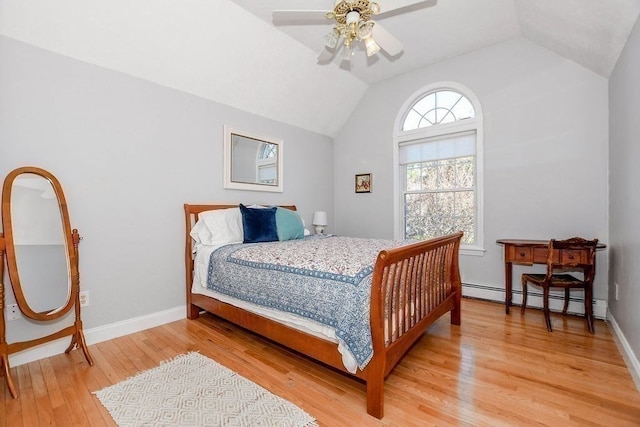 bedroom featuring hardwood / wood-style floors, baseboard heating, ceiling fan, and lofted ceiling