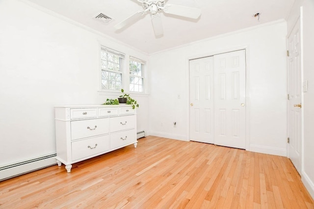 unfurnished bedroom featuring light wood-type flooring, a closet, ceiling fan, and crown molding