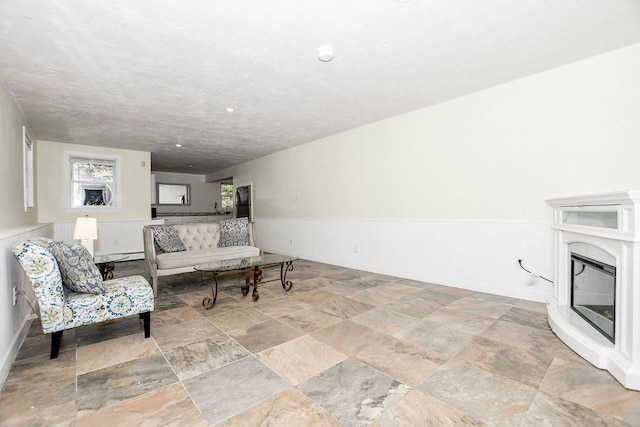 living room with a textured ceiling and a baseboard heating unit