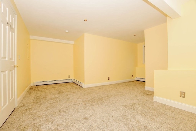 carpeted spare room with baseboard heating